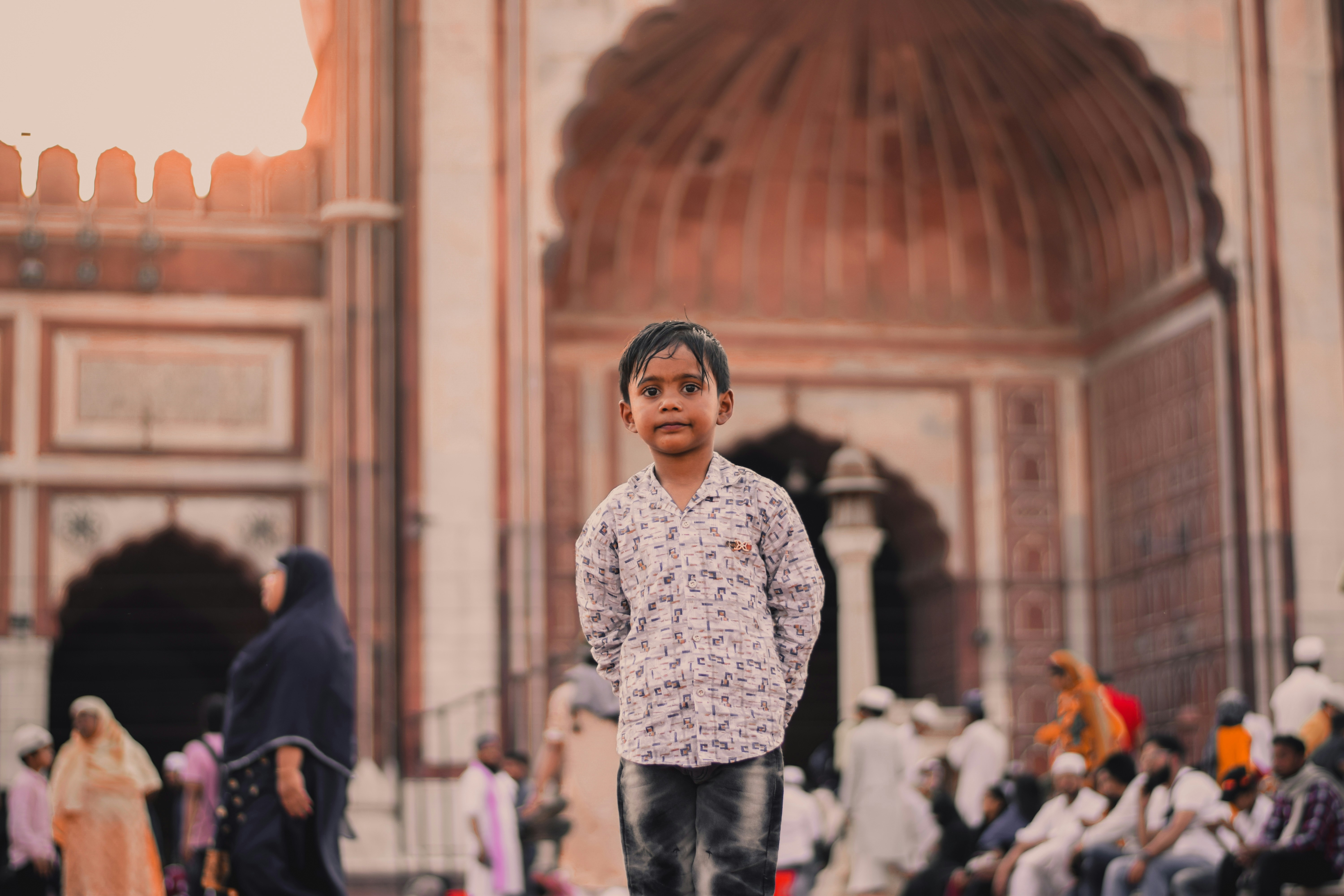 Boy standing in front of building