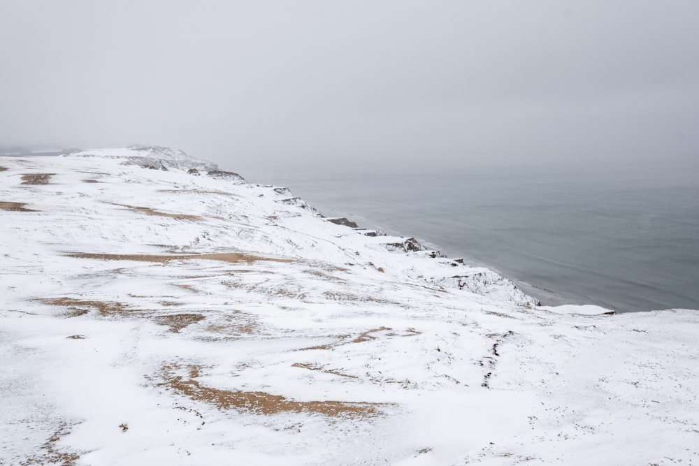 a person standing on top of a snow covered hill