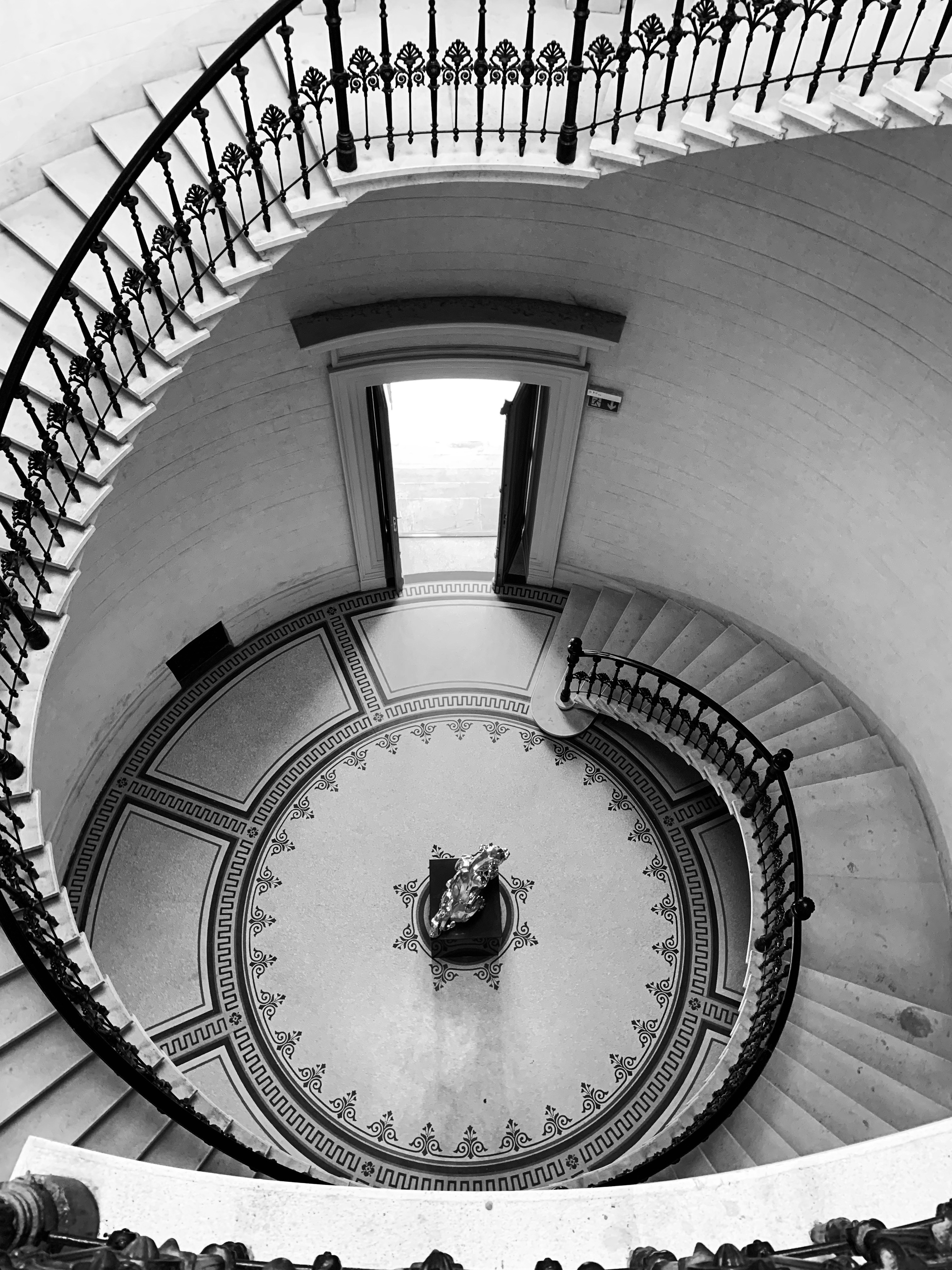 uma escada em espiral com um relógio no centro