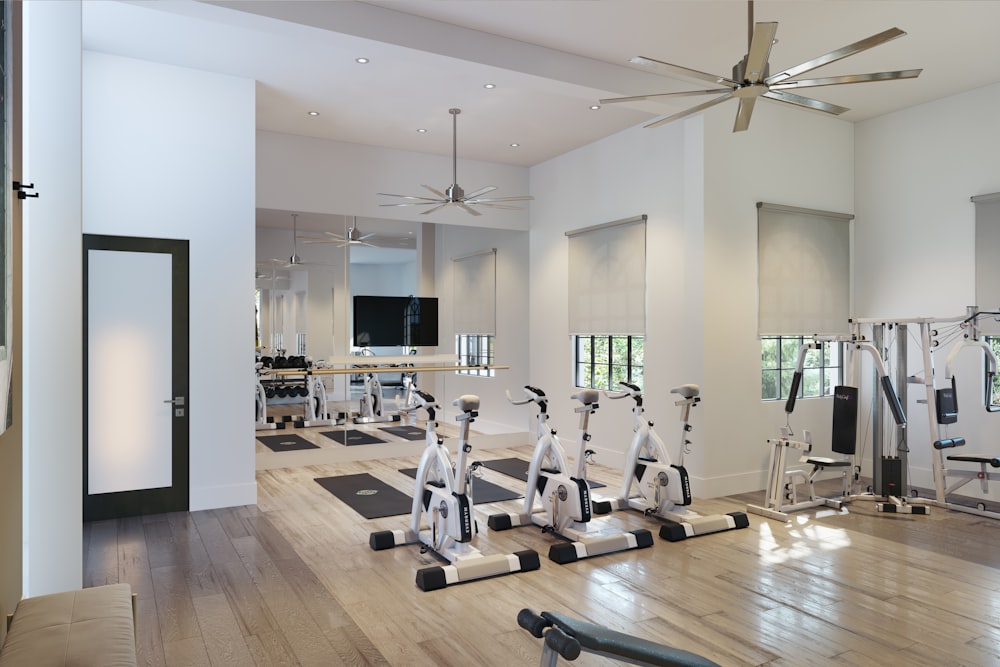 a gym with a ceiling fan and exercise equipment