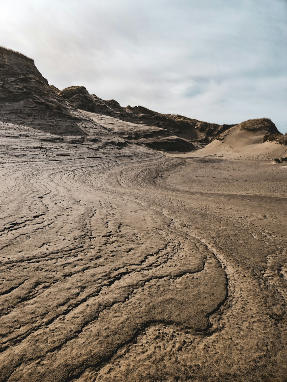 a dirt road in the middle of a desert