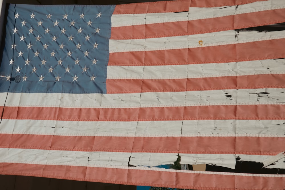 a large american flag hanging on a wall