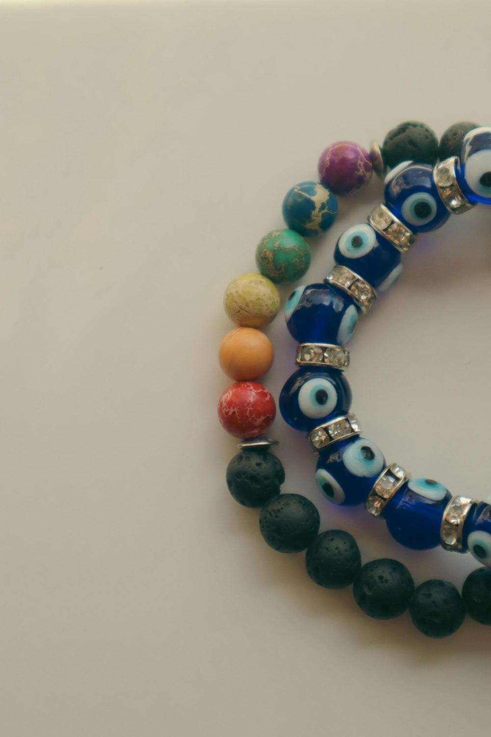 a couple of bracelets with evil eyes on them