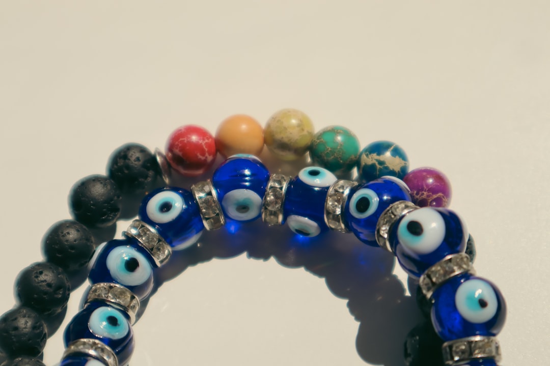 a bunch of bracelets with evil eyes on them,
