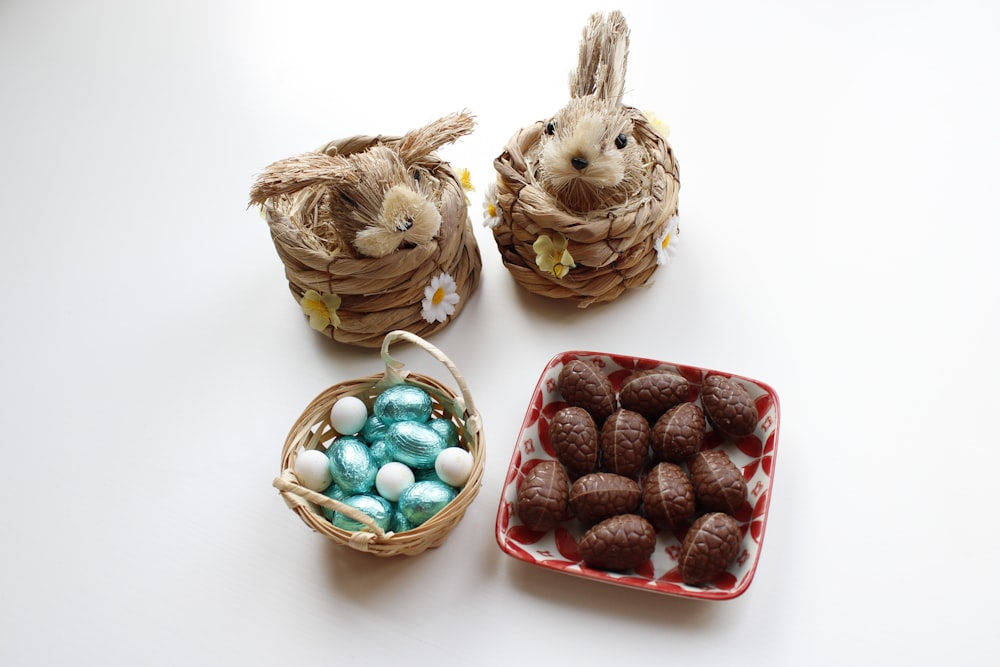 a couple of small baskets filled with chocolate eggs