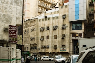 a city street filled with traffic next to tall buildings