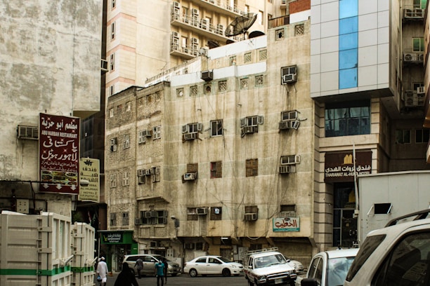 a city street filled with traffic next to tall buildings