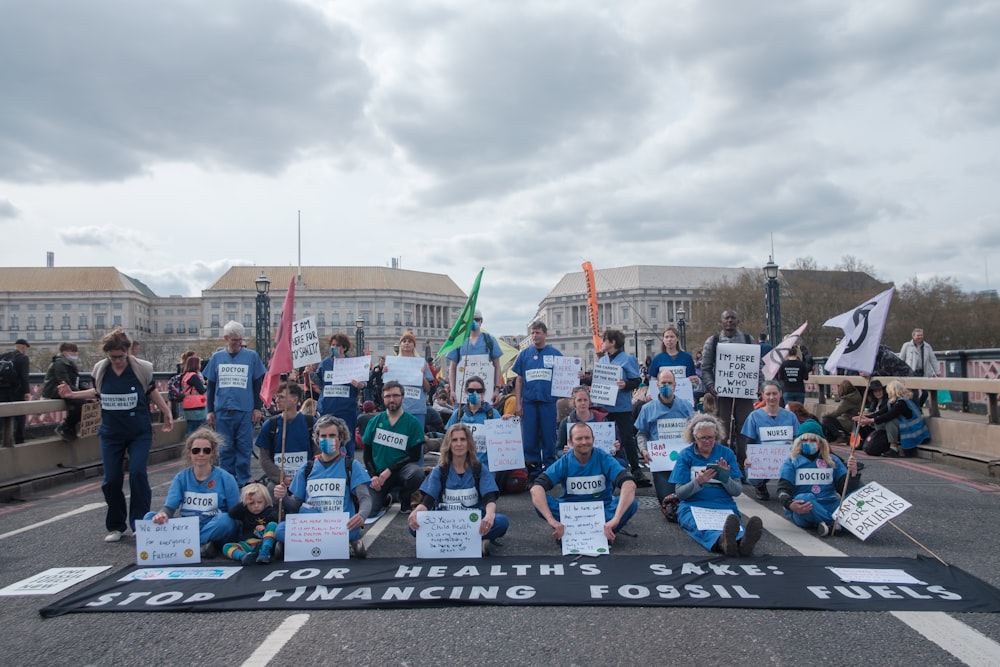 a group of people holding signs on a street