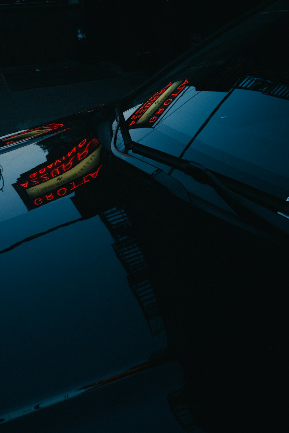 the reflection of a car in the hood of another car