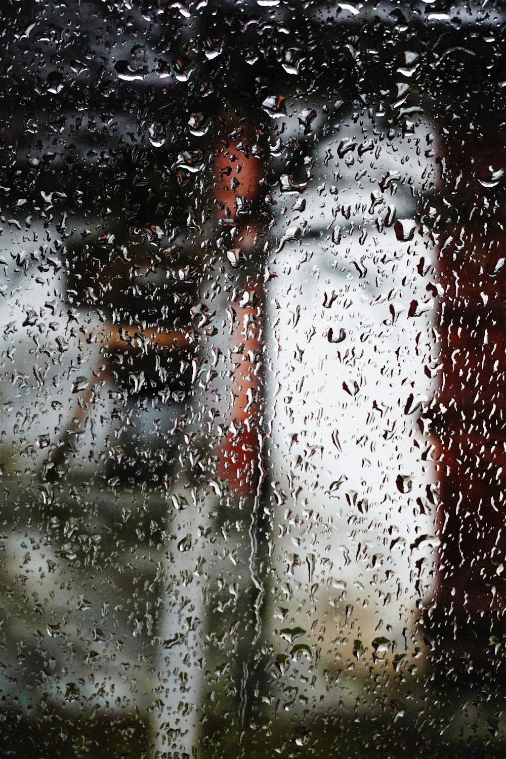 a person standing in the rain holding an umbrella