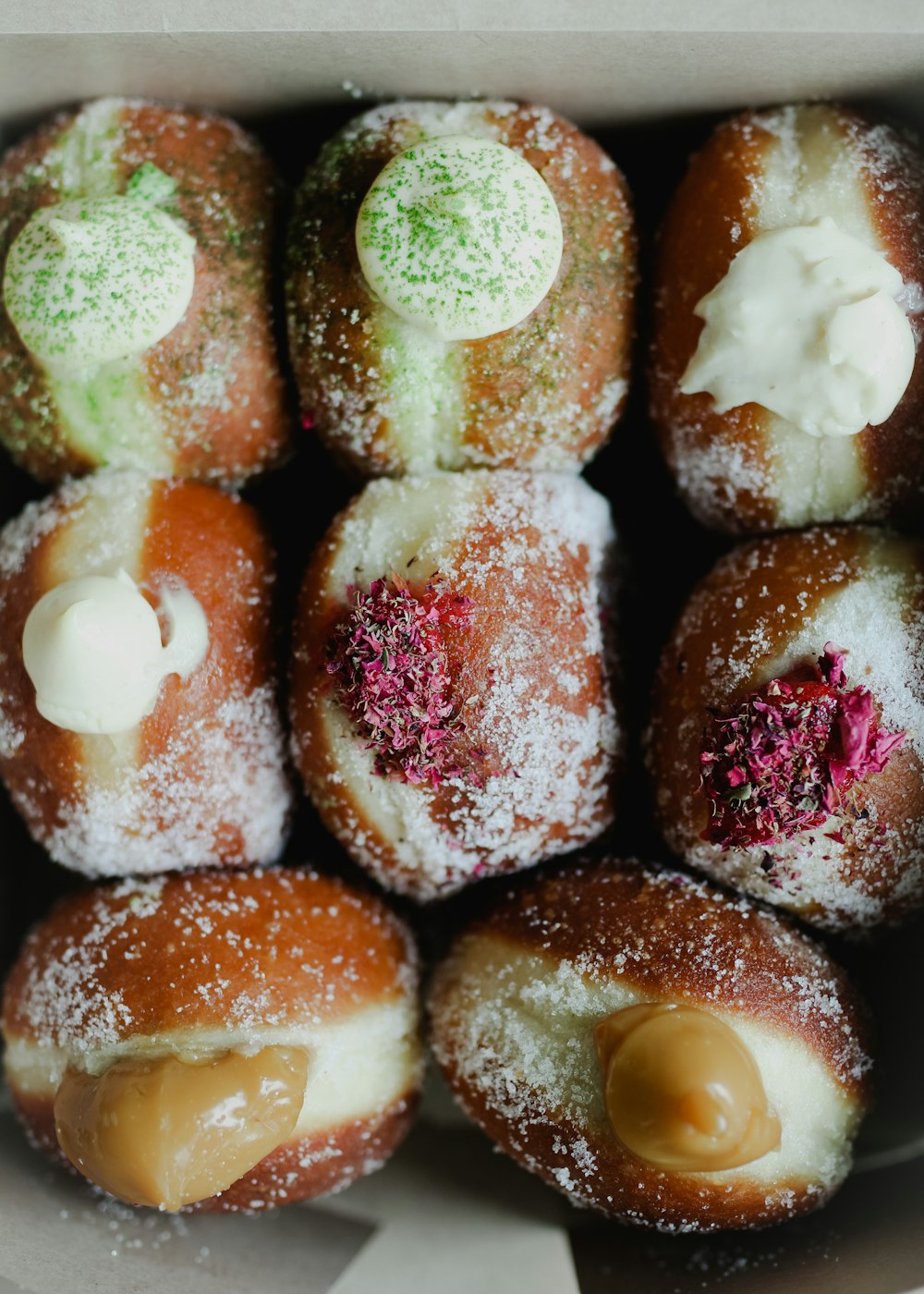 a box filled with donuts covered in powdered sugar