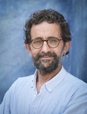 a man with a beard and glasses posing for a picture
