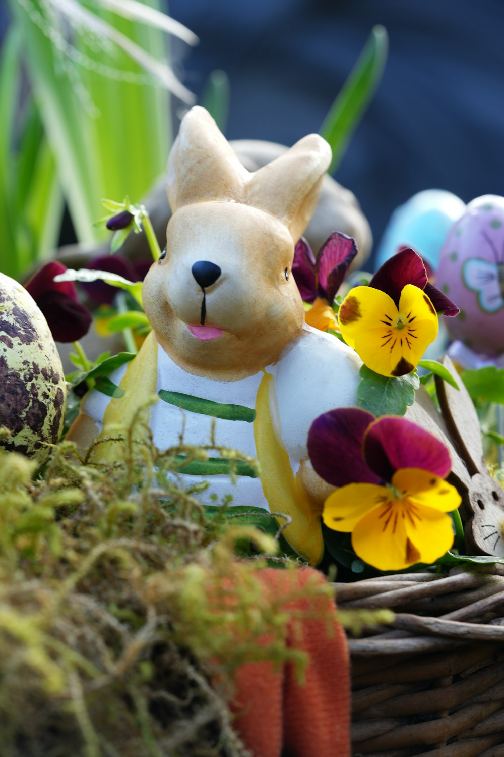 a basket filled with easter eggs and stuffed animals