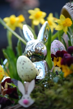 a close up of a basket of eggs and flowers