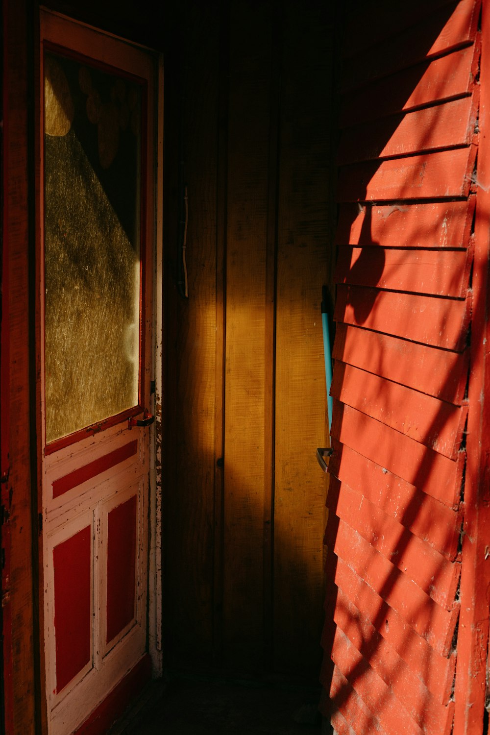 a red door and a brown door with a window