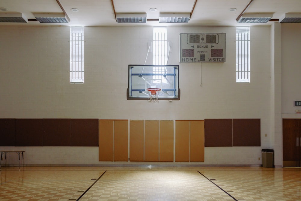 an indoor basketball court with a basketball hoop