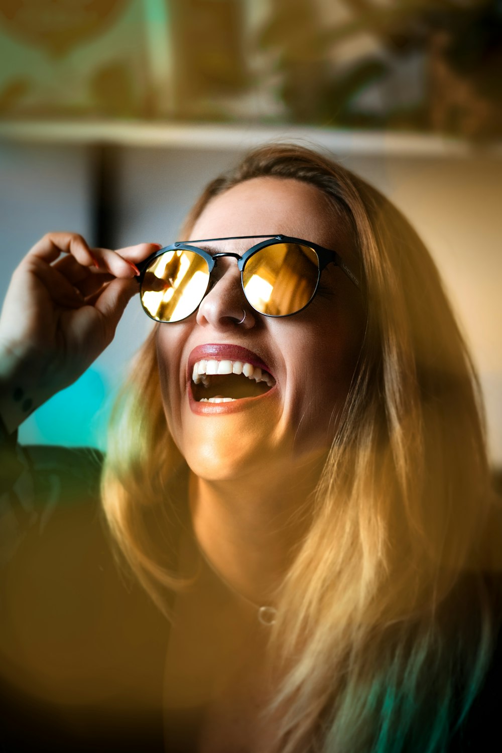 a woman wearing sunglasses looking up at the sky