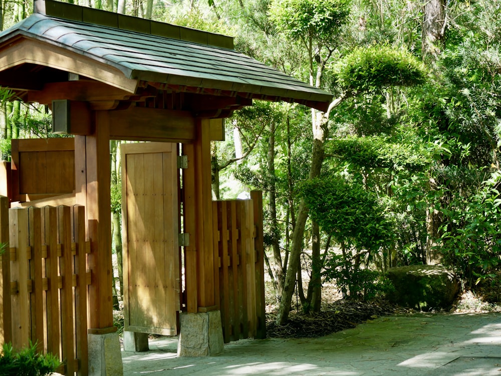 a wooden structure in the middle of a forest