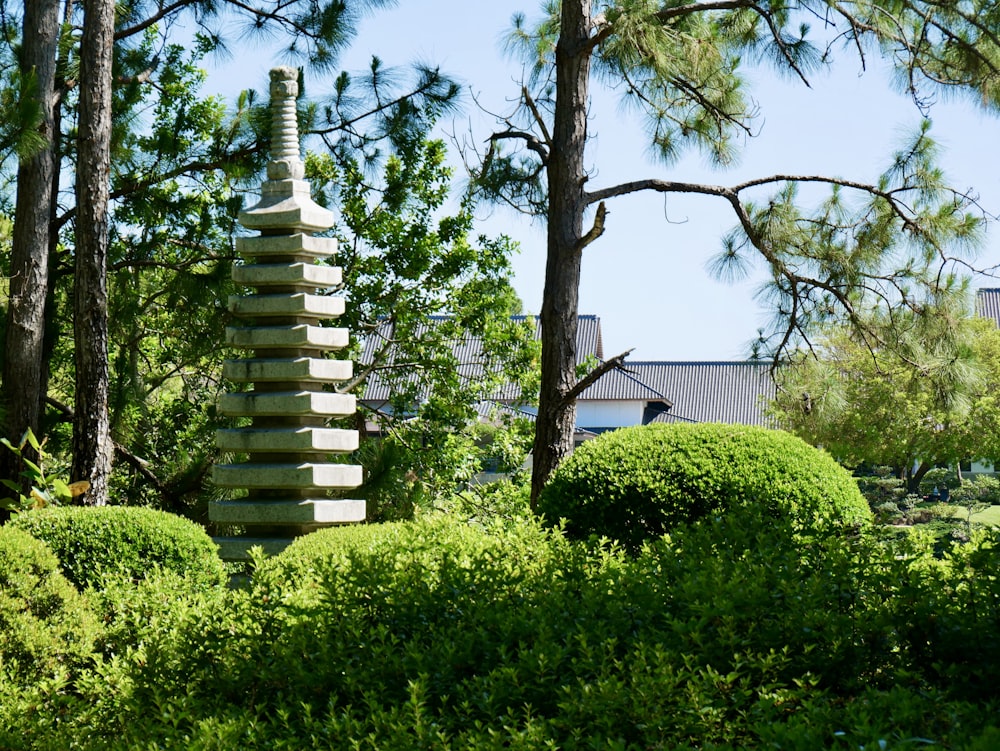 a stone pagoda in the middle of a garden