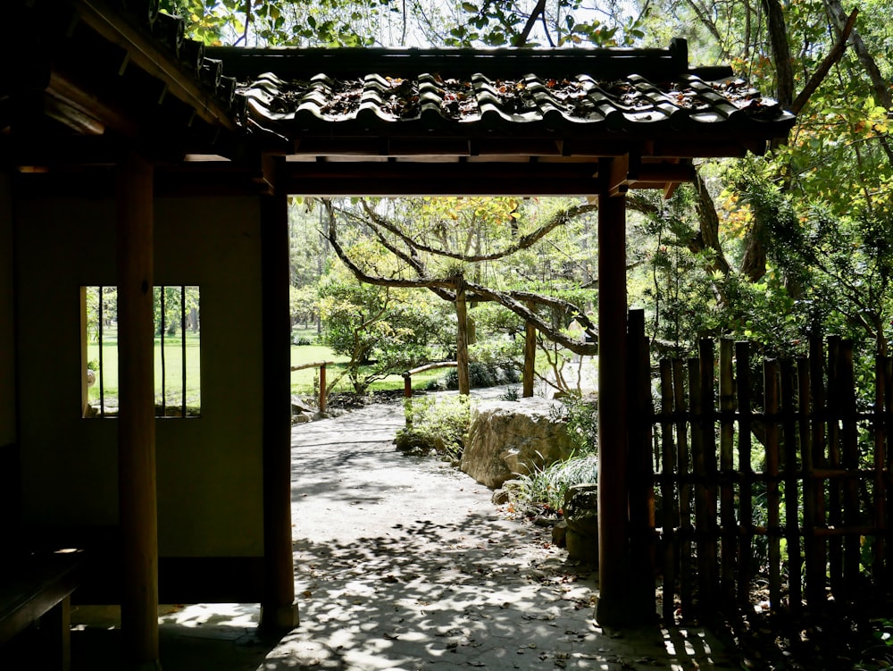 a walkway leading to a garden with trees