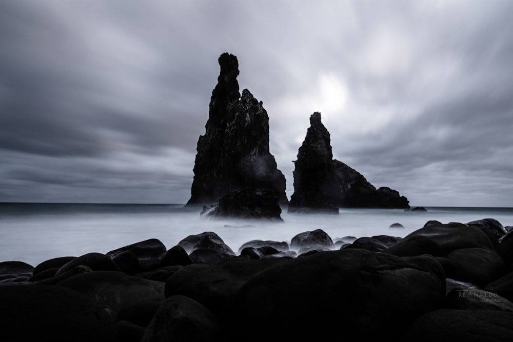 a black and white photo of some rocks and water