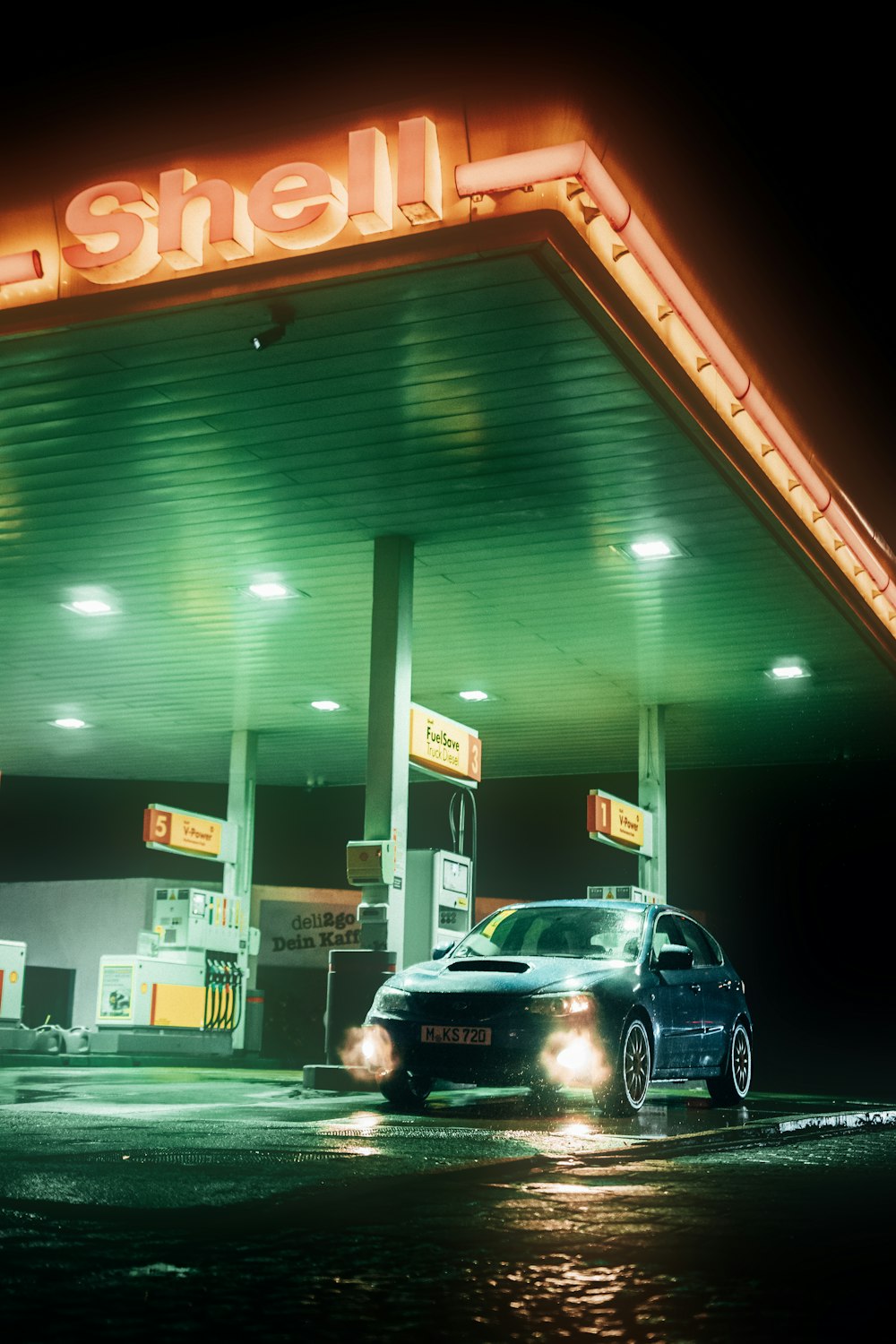 a car parked in front of a gas station