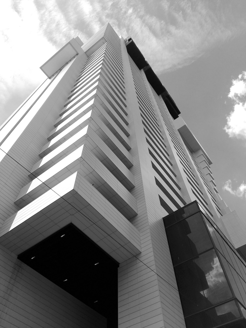 a tall white building with a sky background