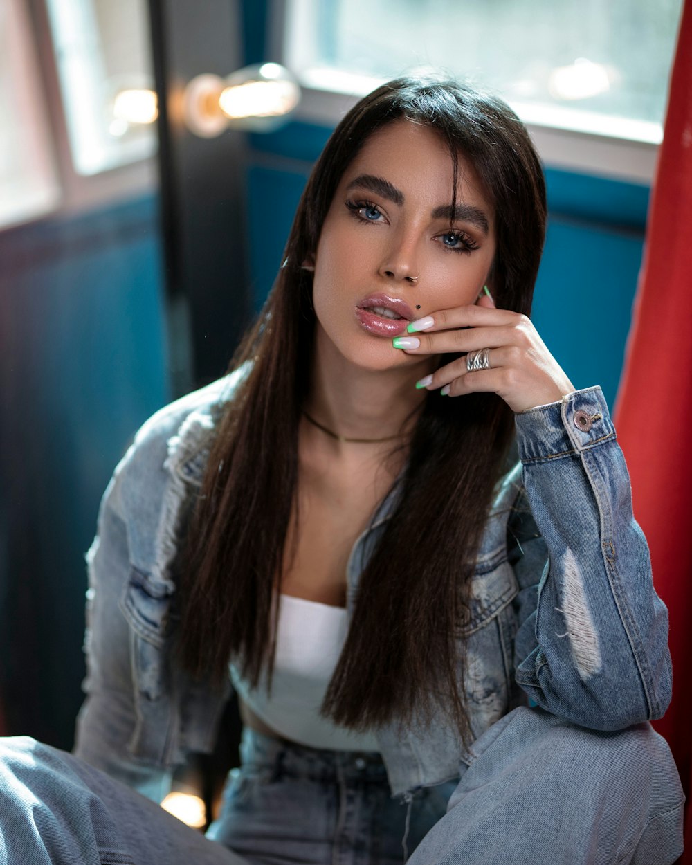 a woman with long hair sitting on a red chair