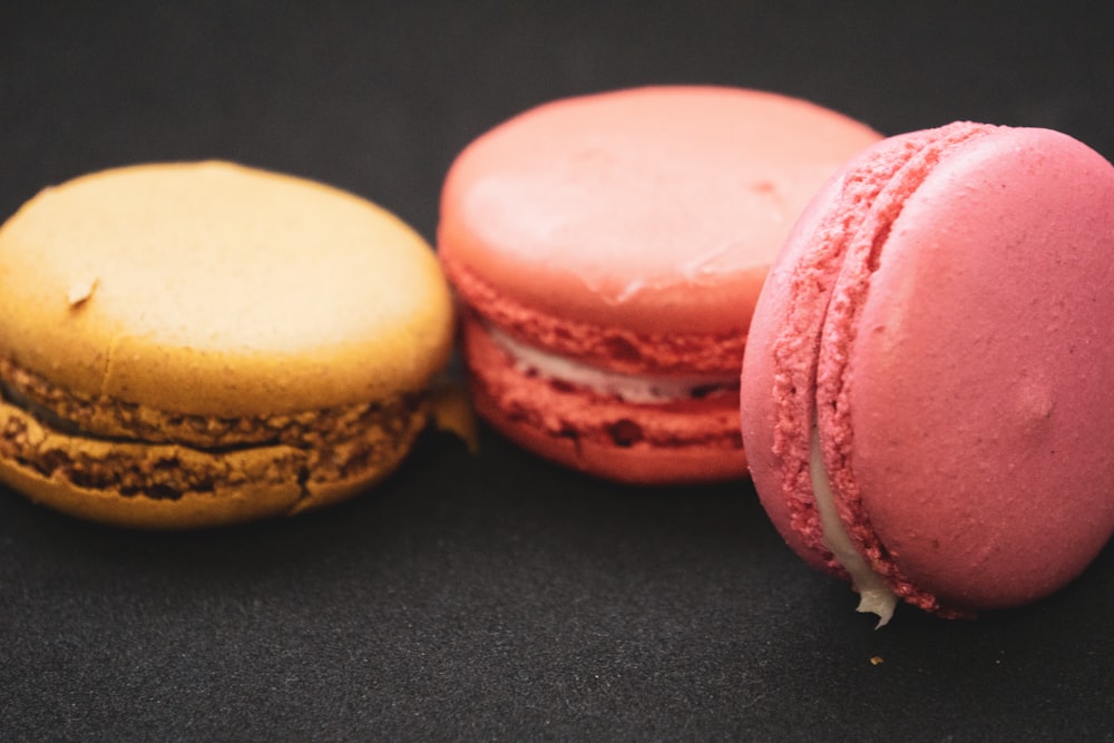 three different colored macaroons sitting next to each other