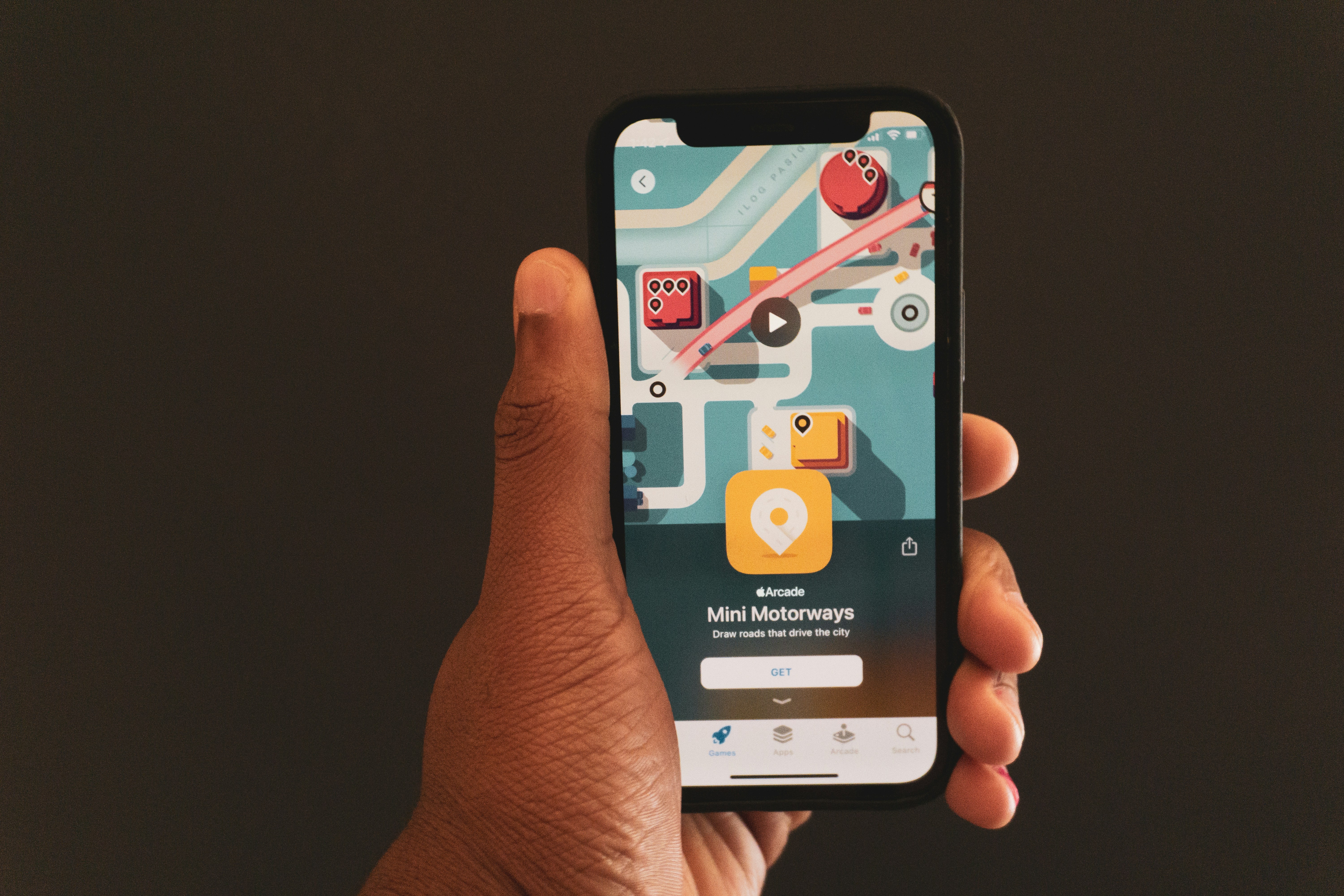 a person holding a smart phone in their hand