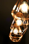 Close-up of custom-made metal lighting fixtures glowing warmly