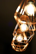 Close-up of custom-made metal lighting fixtures glowing warmly