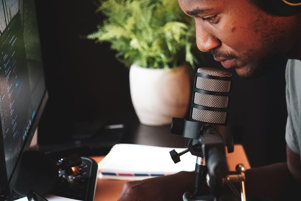 a man with headphones on looking at a computer screen