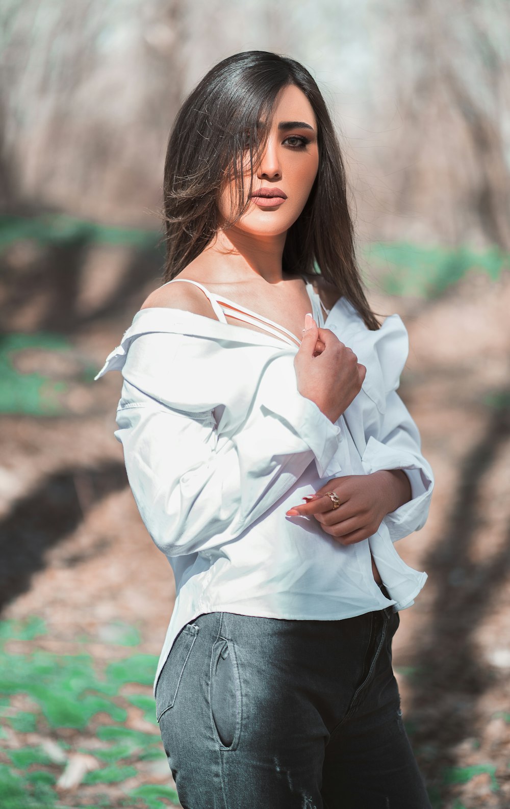 a woman in a white shirt posing for a picture