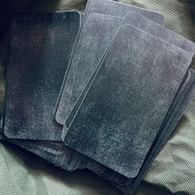 a set of four square coasters sitting on top of a bed