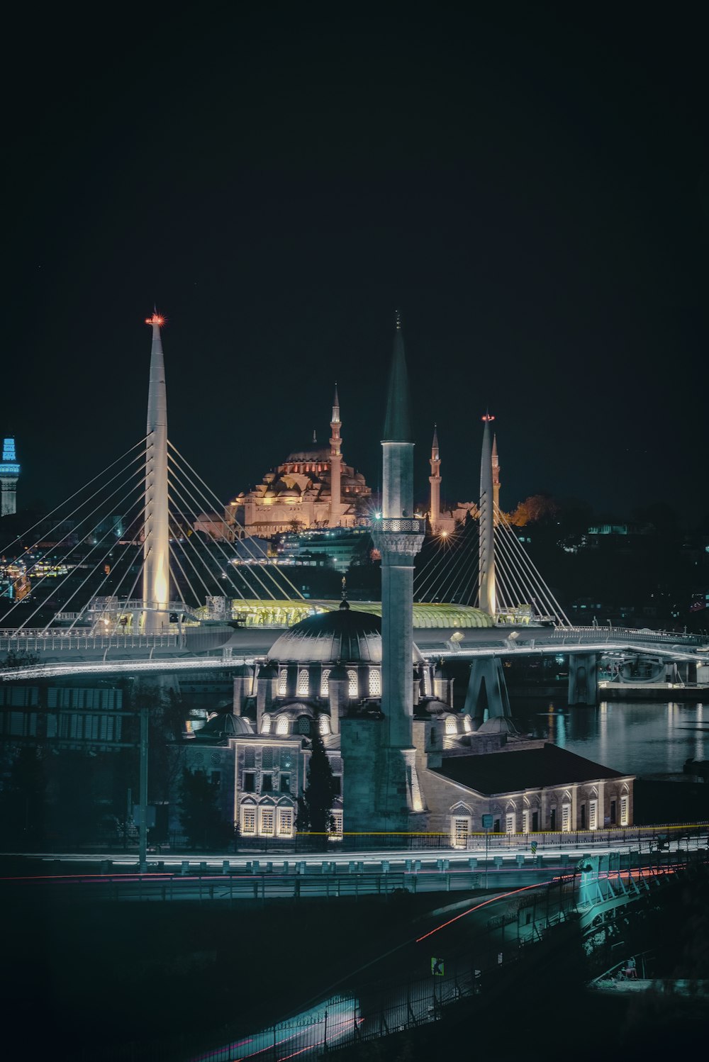 a night view of a bridge with a castle in the background