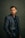 a man in a suit posing for a picture