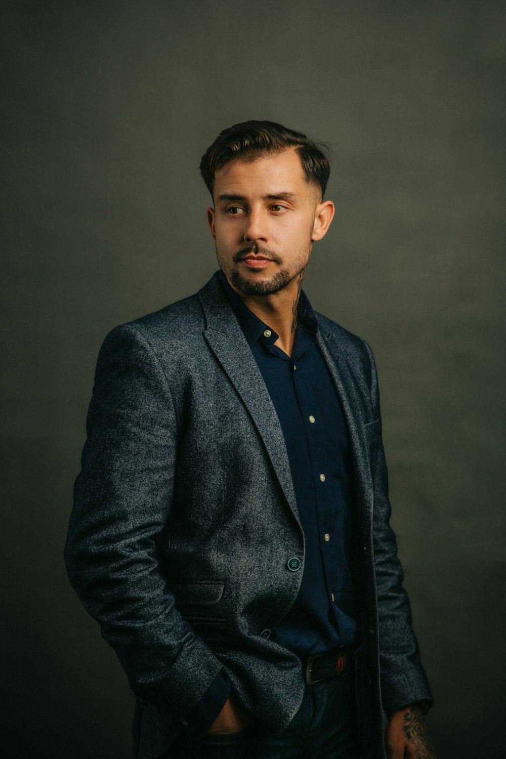 a man in a suit posing for a picture