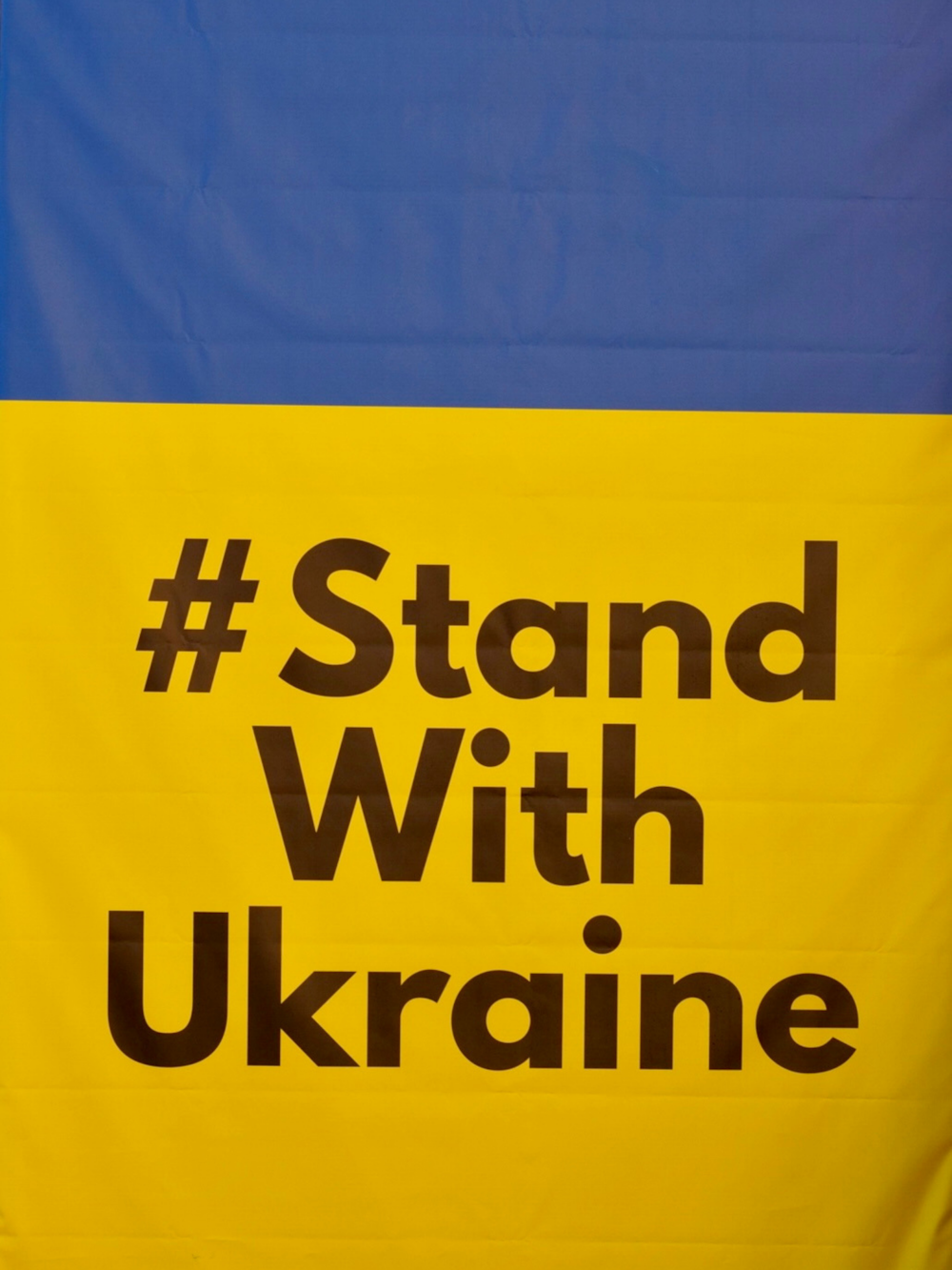 a sign that says stand with ukraine on it