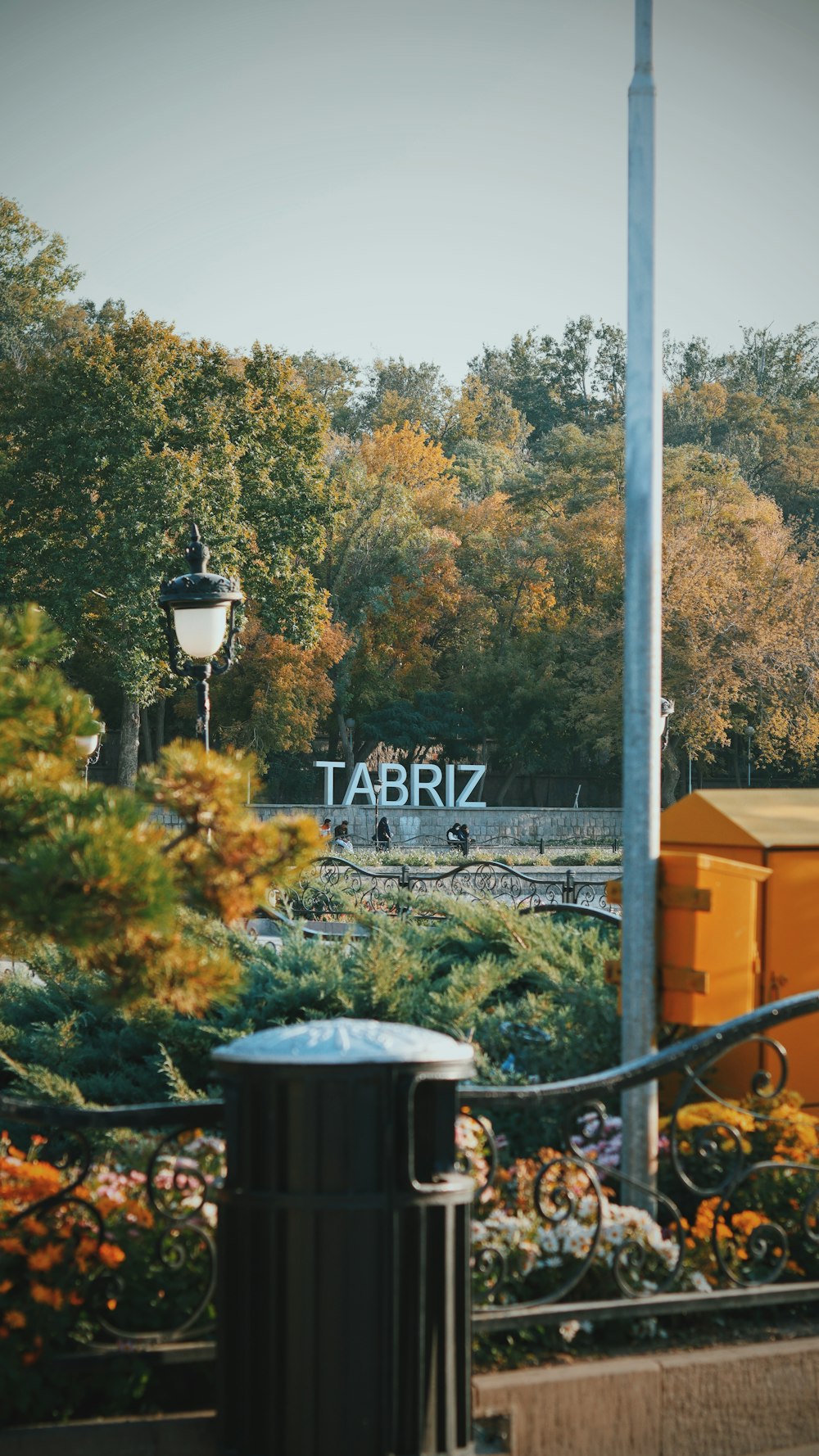 a trash can sitting in front of a train track