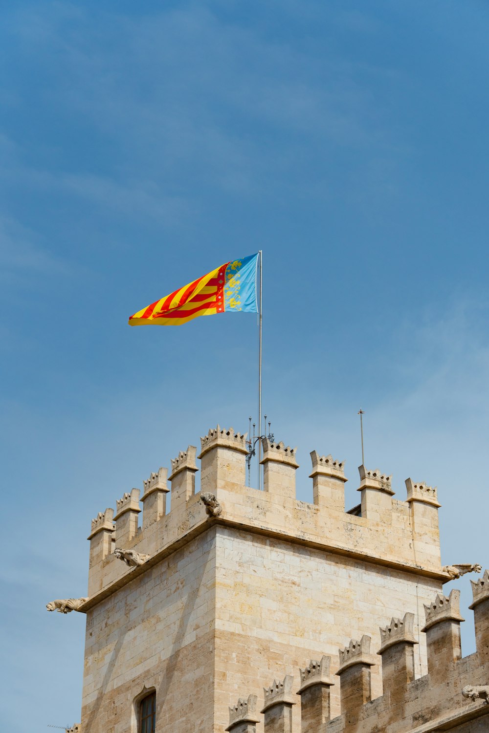 a flag flying on top of a tall building