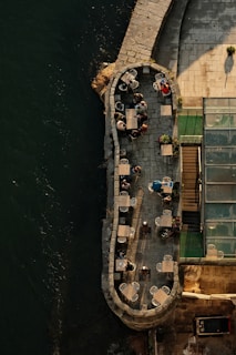 A cozy riverside café bustling with visitors sipping coffee and enjoying the view.