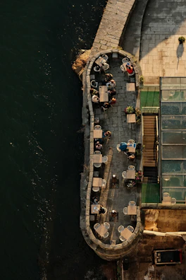 Guests enjoying morning coffee on the riverside patio surrounded by greenery.