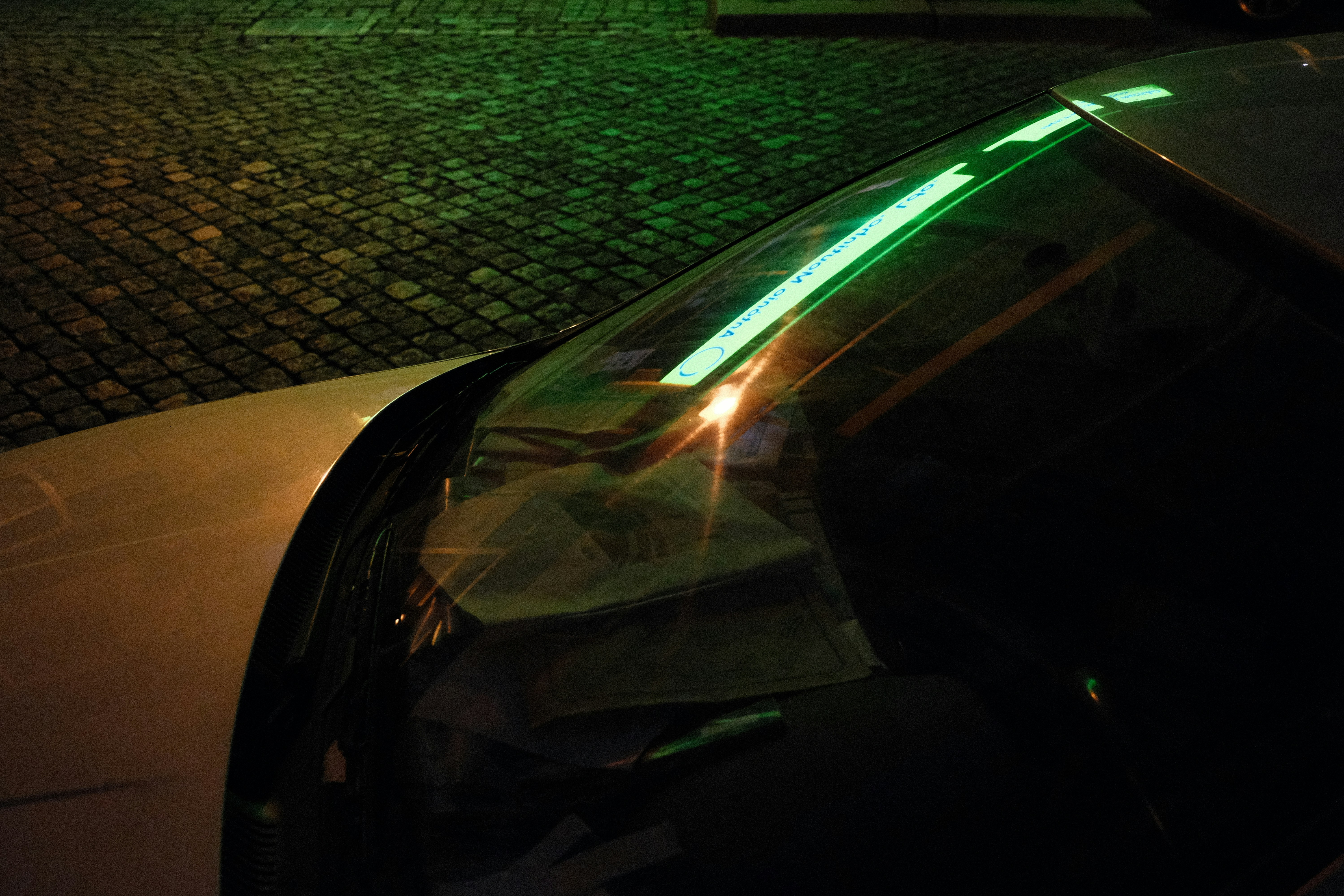 Lucid Air viewed from the rear at night with full-width taillight illuminated