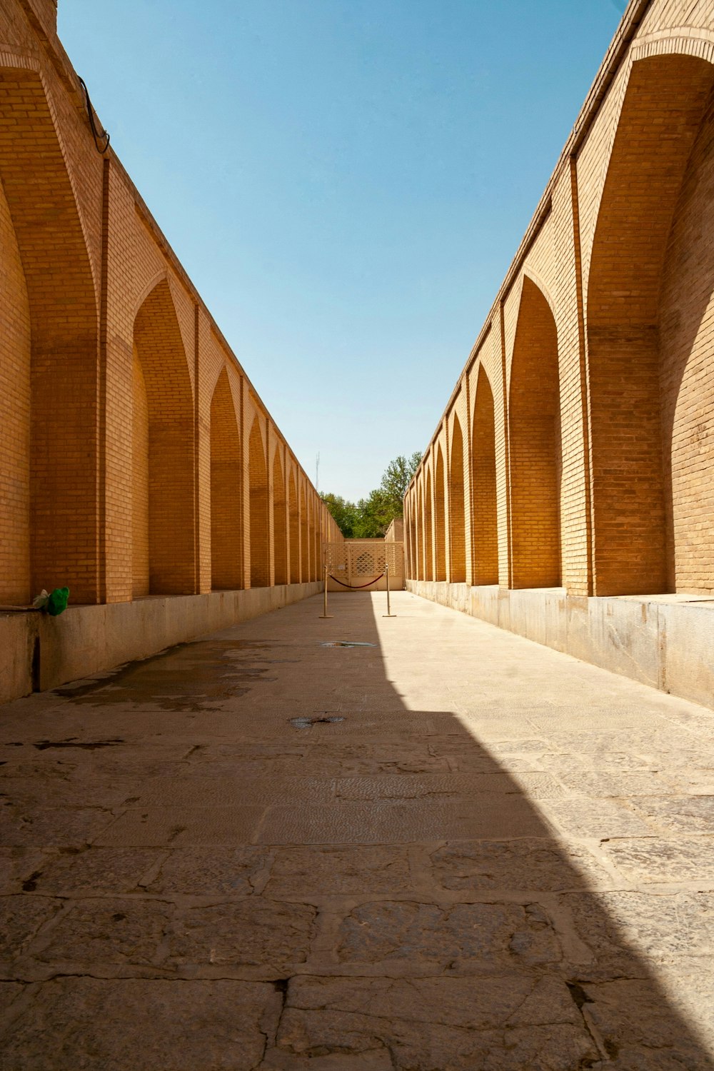 a stone bridge in front of a brick building