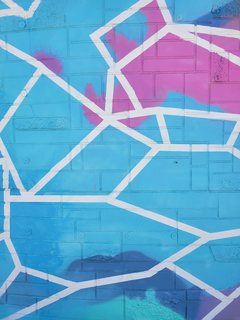 a blue and pink wall with white lines on it