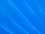 a close up of a surfboard on a blue surface