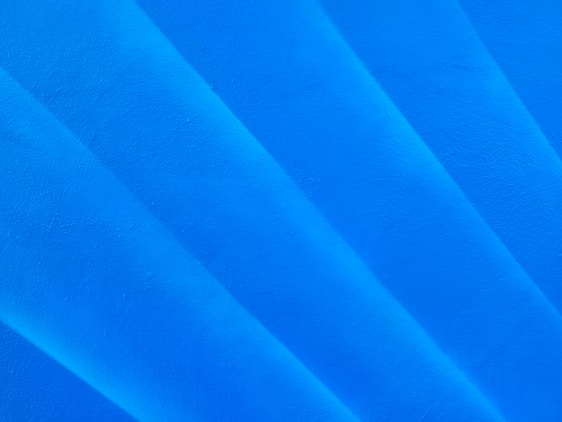 a close up of a surfboard on a blue surface