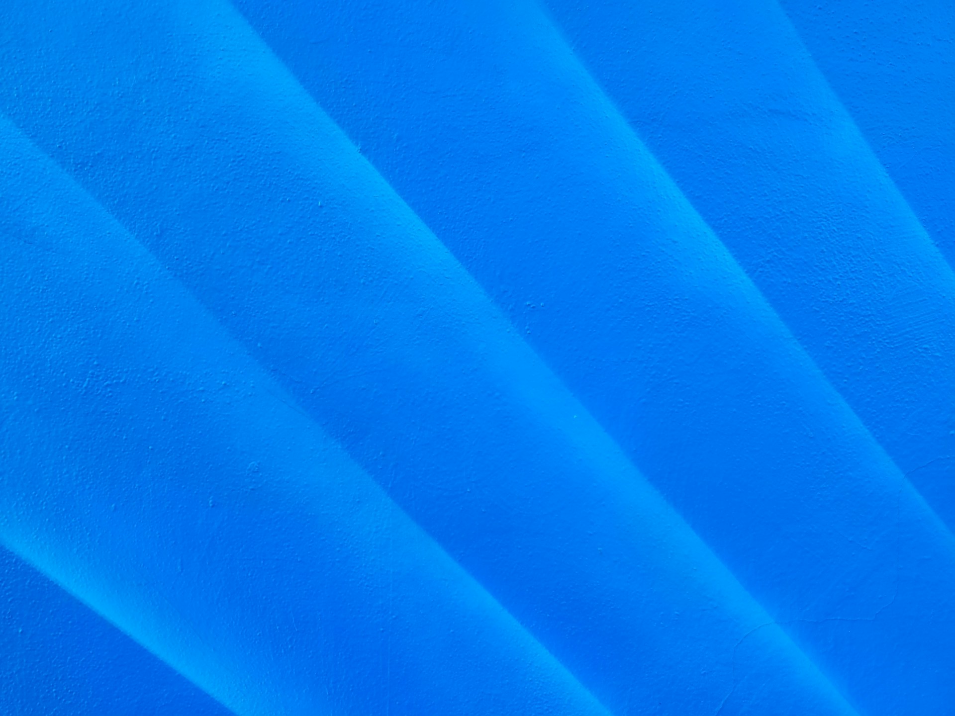 a close up of a surfboard on a blue surface