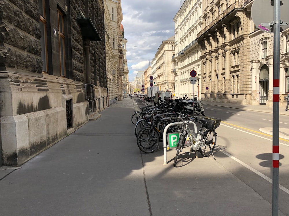 a row of parked bicycles sitting on the side of a road